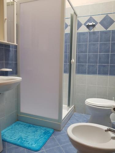 a bathroom with a shower and a toilet and a sink at Camping Villaggio Egad in Favignana