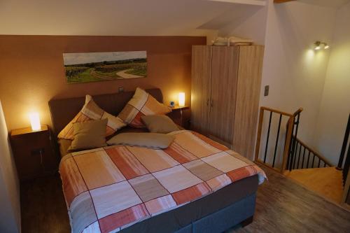 a bedroom with a bed with two lights on at Ferienwohnung Familie Westermann in Kapellen-Drusweiler