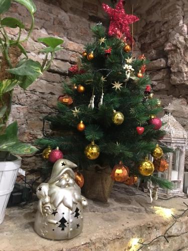 a christmas tree sitting next to a small christmas tree at Barbara’s rooms in Chioggia