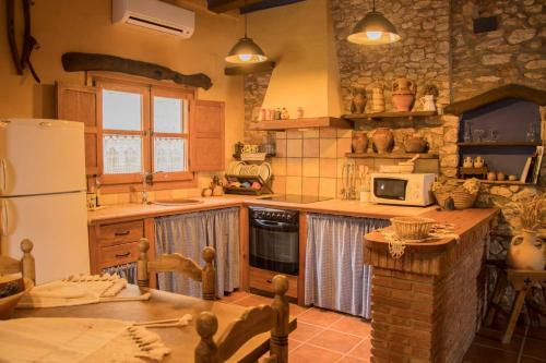 a kitchen with a refrigerator and a stove top oven at Amborget in Sant Jordi