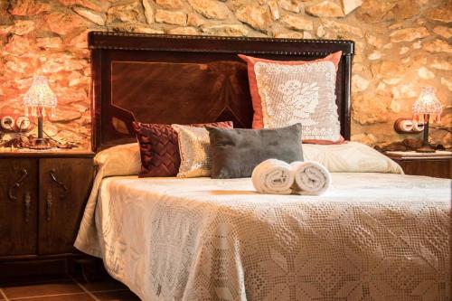 a bedroom with a bed with towels on it at Amborget in Sant Jordi