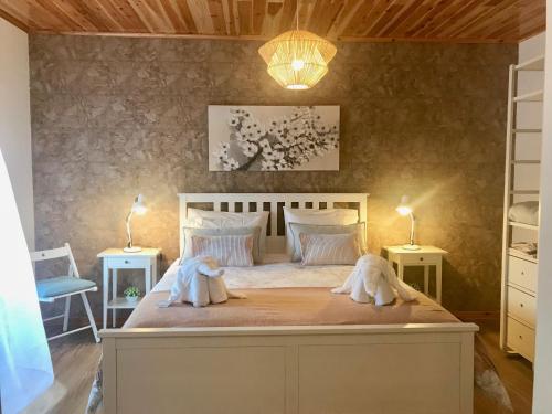 a bedroom with two dogs laying on a bed at Casa do Priolo - Villaverde Azores in Feteiras