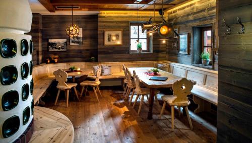 a dining room with a wooden table and chairs at Lifestyle Hotel eder in Maria Alm am Steinernen Meer