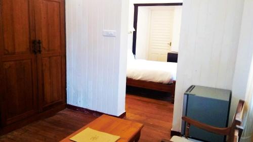 a room with a room with a bed and a table at Dutch Bungalow in Cochin