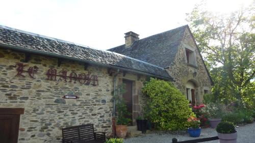 a building with a sign on the side of it at B&B Manoir de la Fabrègues in Estaing