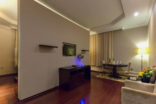 a living room with a couch and a table at Holiday Jazan Hotel in Jazan