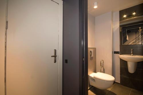 a bathroom with a toilet and a sink at New Gudauri Loft 1 #440 in Gudauri