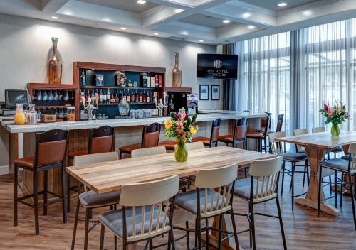 a restaurant with tables and chairs and a bar at The Hotel Concord in Concord