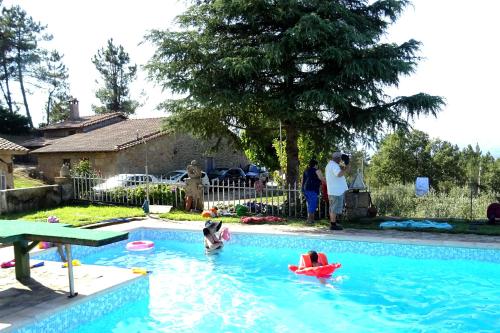 a group of people playing in a swimming pool at Quinta Vale da Ginjeira in Quinta da Carrapata