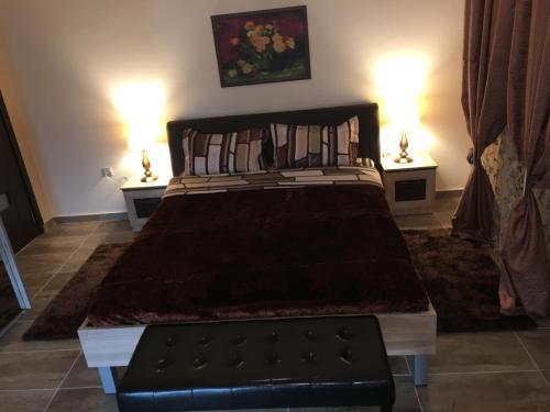 a bedroom with a large bed with two lamps at Archontiko Kirfis in Desfina in Dhesfína