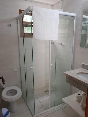 a bathroom with a shower with a toilet and a sink at Beach House Floripa - Sunset in Florianópolis
