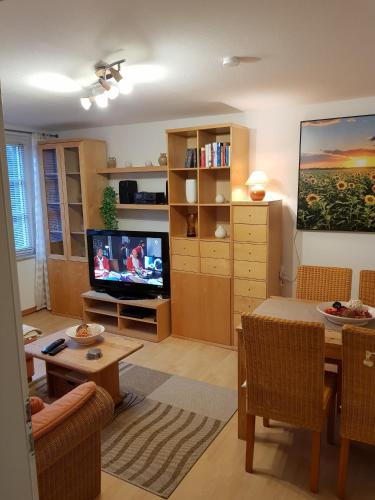 a living room with a table and a television at Appartmenthaus Gingst in Gingst