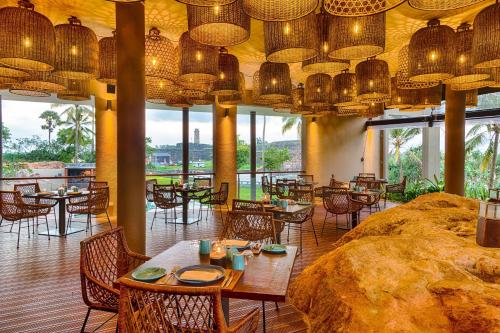 a restaurant with tables and chairs and chandeliers at Le Grand Galle By Asia Leisure in Galle