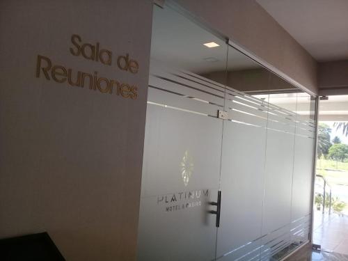 a glass wall in a building with a sign on it at Platinum Hotel Casino in Villa Ángela