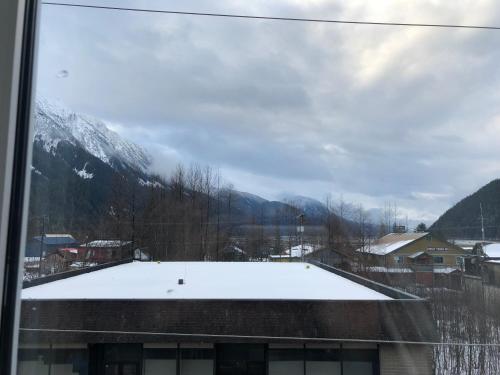 a view of a snowy mountain from a window at Historic Hotel Bayview in Stewart