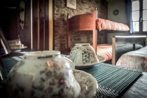 two vases sitting on a table in a room at l'Oca Mannara in Ameno