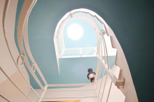 an arched staircase with a window in a blue wall at Beach Villas & Apartments Larimar in Punta Cana