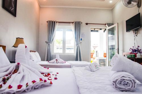 a bedroom with two beds with flowers on them at Anna Nguyễn Bungalow in Phú Quốc