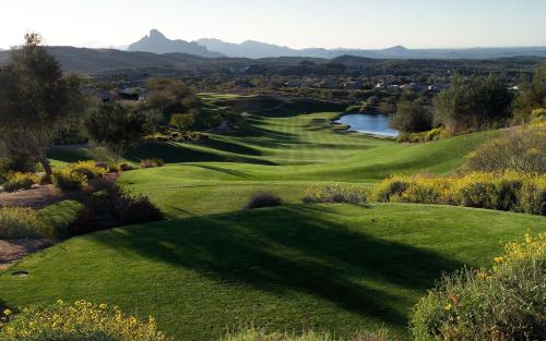 a view of a golf course with a green and a river at Atascadero Inn in Atascadero