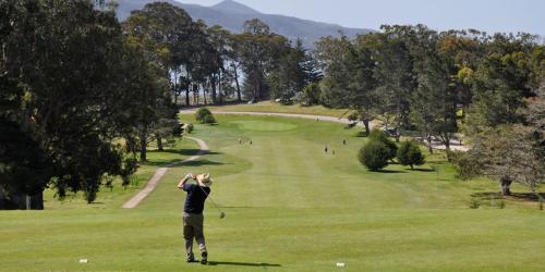 a man is playing golf on a golf course at Atascadero Inn in Atascadero
