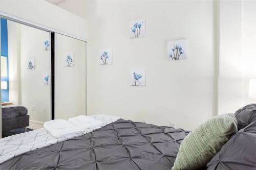 a bedroom with a bed and a mirror at Trifecta 2BR Free Parking Modern Superhost in Durham
