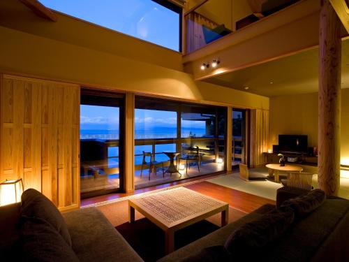 a living room with a couch and a large window at Amahara in Sumoto