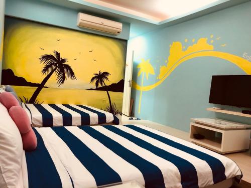 a bedroom with a bed with a painting on the wall at Enjoy Kenting in Kenting