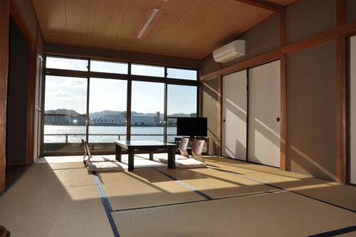 a living room with a view of the water at Riverside Hotel Karatsu Castle in Karatsu