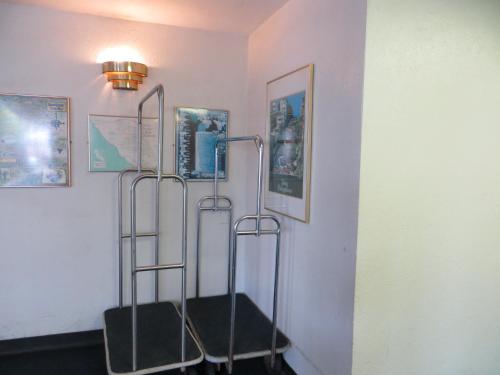 a room with two towel racks on a wall with pictures at Royal Pacific Motor Inn in San Francisco