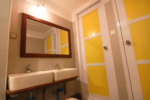 a bathroom with a sink and a mirror at Ostello Bello Mandalay in Mandalay