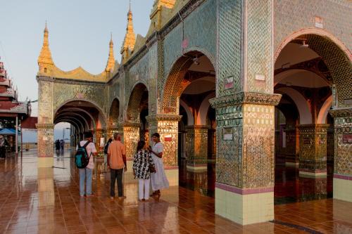 a group of people standing in a building at Ostello Bello Mandalay in Mandalay