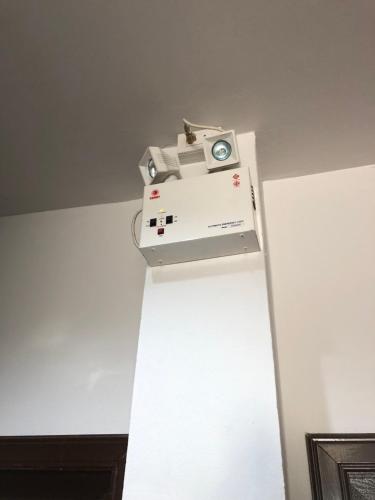 a machine sitting on top of a white wall at Rabbit Hotel in Phetchabun