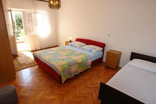 a bedroom with a bed and two beds in it at Apartments Darinka in Sevid