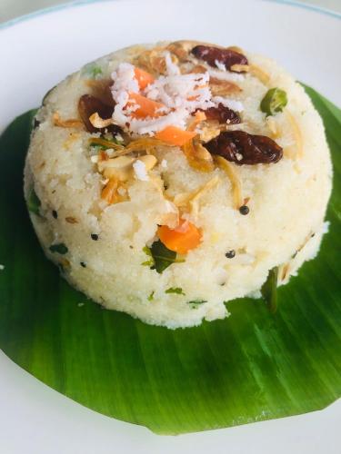 a piece of food sitting on top of a green leaf at Abad Turtle Beach in Mararikulam