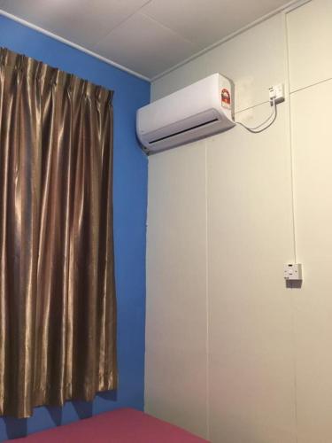 a room with a air conditioner on the wall at D'Gaia Homestay Sandakan in Sandakan