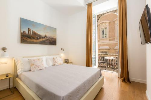 Amazing Piazza Venezia Suites tesisinde bir odada yatak veya yataklar