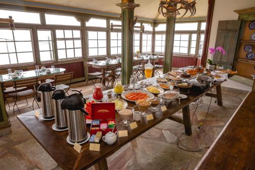 a long table with food on it in a restaurant at Hotel Vila Relicário in Ouro Preto