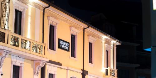 a yellow building with a sign on the side of it at RESIDENZE CASSOLI - Lamezia Centro in Lamezia Terme