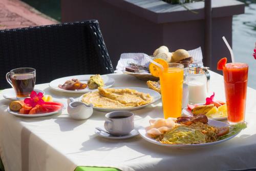 a table with plates of breakfast food on it at Toba Village Inn in Tuk Tuk