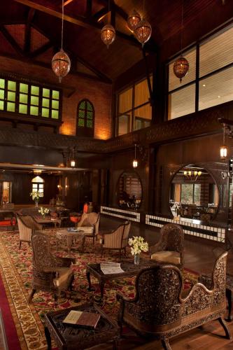 a large room with tables and chairs in a building at The Khyber Himalayan Resort & Spa in Gulmarg