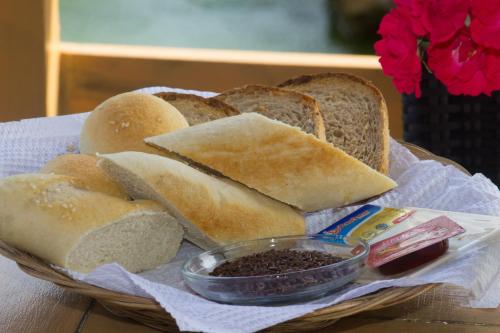 a basket filled with bread and a bowl of jam at Toba Village Inn in Tuk Tuk