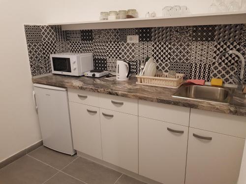 a kitchen with a sink and a microwave at Lux Apartment in Belgrade 2 in Belgrade