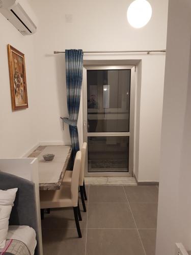 a dining room with a table and a table and a window at Lux Apartment in Belgrade 2 in Belgrade