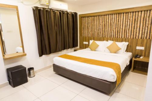 a hotel room with a large bed and a window at The Porch Inn Hotel/Service Apartments in Bengaluru