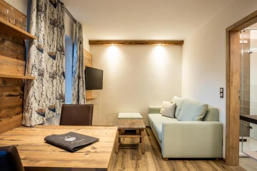 a living room with a couch and a table at Haus am Rank in Oberstdorf