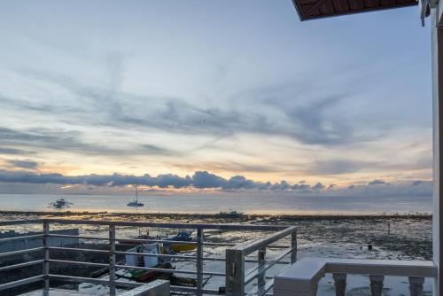 a view of a beach with a cloudy sky at Kellocks' Seaview Apartelle in Dalaguete