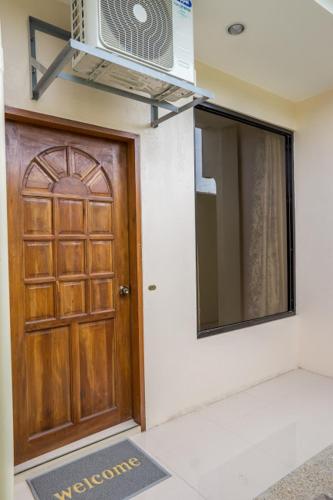 a door of a house with a microwave above it at Kellocks' Seaview Apartelle in Dalaguete