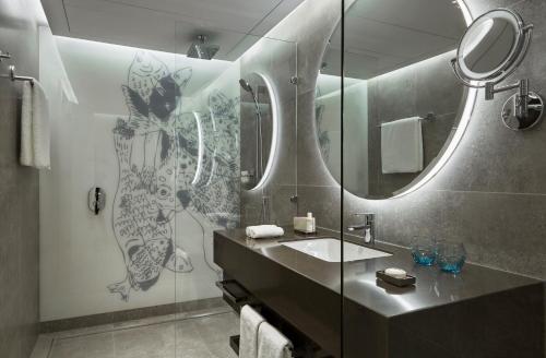 a bathroom with a sink and a mirror at The Merchant House in Manama