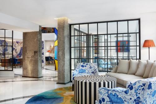 a lobby with blue and white chairs and a couch at The Merchant House in Manama