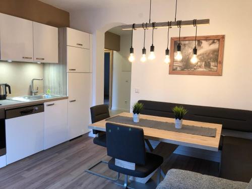 a kitchen and dining room with a table and chairs at Haus Central Lofer in Lofer